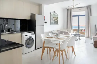 a kitchen and dining room with a table and chairs at Modern 1BR with Pool & Gym, Burj Khalifa View, Al Jaddaf in Dubai
