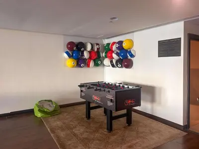 a room with a ping pong table and balloons on the wall at Frank Porter - Al Tajer Residences in Dubai