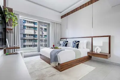 a bedroom with a large bed and a large window at Frank Porter - Blvd Central in Dubai