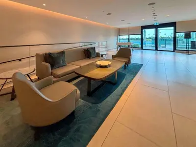 a living room with a couch and chairs and a table at Frank Porter - Address Beach Resort Tower in Dubai
