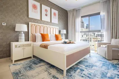 a bedroom with a large white bed with orange pillows at Frank Porter - Eleganz 2 by Danube in Dubai