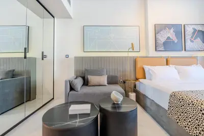 a bedroom with a bed and a couch and a chair at TRPS - MAG 318, Business Bay - Walk to Dubai Mall, Furnished Apt, Premium Amenities in Dubai