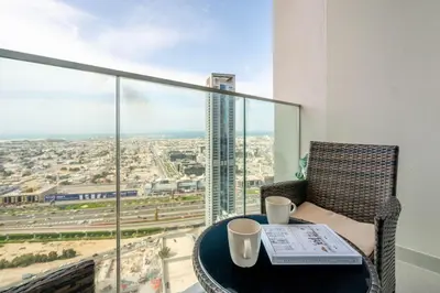 a table with two coffee cups and a newspaper on it at GuestReady - Forte Tower | Steps from Dubai Mall in Dubai