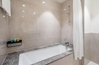 a bathroom with a bath tub and a shower at GuestReady - Forte Tower | Steps from Dubai Mall in Dubai