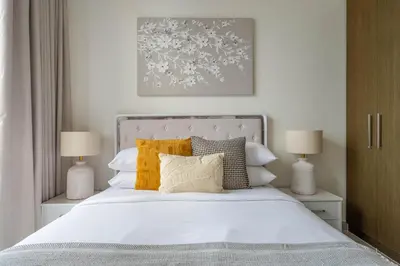 a bedroom with a bed with white sheets and pillows at GuestReady - Forte Tower | Steps from Dubai Mall in Dubai