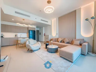 a living room with a couch and a table at Enjoy Best Burj Khalifa View from Balcony Next to Dubai Mall Luxury 2BR Like Home in Dubai