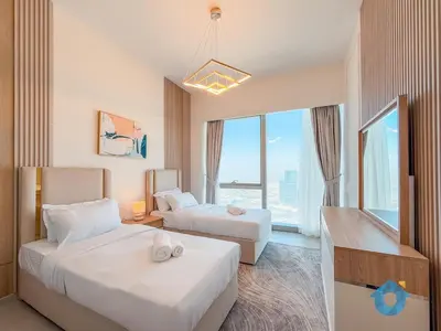 a hotel room with two beds and a large window at Enjoy Best Burj Khalifa View from Balcony Next to Dubai Mall Luxury 2BR Like Home in Dubai