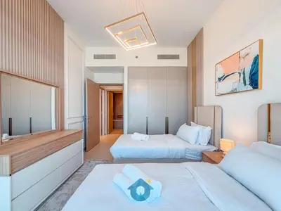 a hotel room with two beds and a mirror at Enjoy Best Burj Khalifa View from Balcony Next to Dubai Mall Luxury 2BR Like Home in Dubai