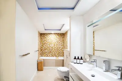 a bathroom with a toilet and a shower at Lux 2BR Beachfront ap with icon Palm view in Dubai