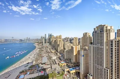 a view of a city with a beach and buildings at Lux 2BR Beachfront ap with icon Palm view in Dubai
