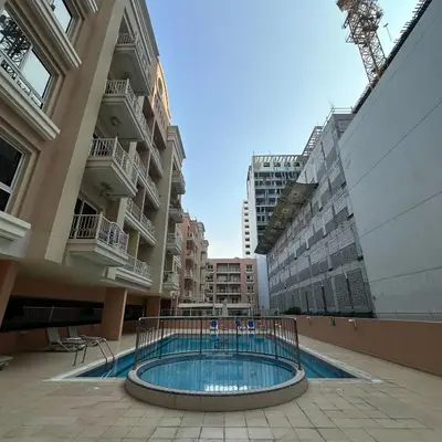 a swimming pool in the middle of a building at Stylish Studio Apartment in JVC in Dubai