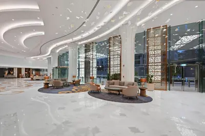 a lobby with chairs and tables in a building at Stunning 1BR Luxury Downtown Burj View Balcony in Dubai