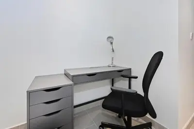 a desk with a black chair next to a desk at Stunning 1BR Luxury Downtown Burj View Balcony in Dubai