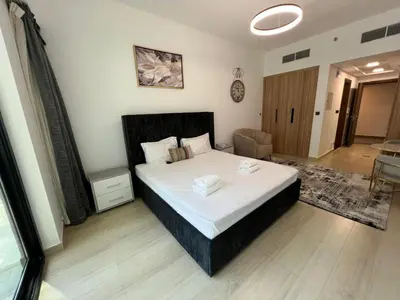 a bedroom with a large bed in a room at Captivating Studio in Jvc Elysee in Dubai