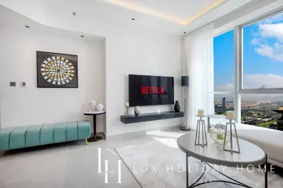 a living room with a couch and a table at LUX The Dubai Marina View Suite 3 in Dubai