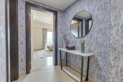 a hallway with a mirror and a table at Red Residence, Sports City - 2 Bedroom Apartment - Allsopp & Allsopp in Dubai