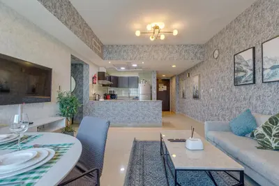 a living room with a couch and a table at Red Residence, Sports City - 2 Bedroom Apartment - Allsopp & Allsopp in Dubai