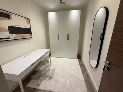 a white bathroom with a sink and a mirror at Crest haven suite in Dubai
