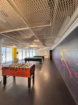 a room with two pool tables and a wall with graffiti at DT Penthouse • 250sqm • Billiards • Terrace & Pool in Dubai