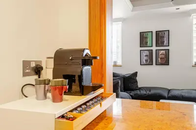 a kitchen with a coffee machine on a counter at DT Penthouse • 250sqm • Billiards • Terrace & Pool in Dubai