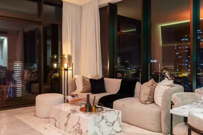 a living room with a couch and a table at 3BR Ultra Luxury Waterfront Panoramic Views with Pool, Gym, Jacuzzi -10 mins to Burj Khalifa in Dubai