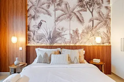 a bedroom with a bed with a large wall mural at Stylish 1BR in CityWalk, Stunning Burj Khalifa view in Dubai