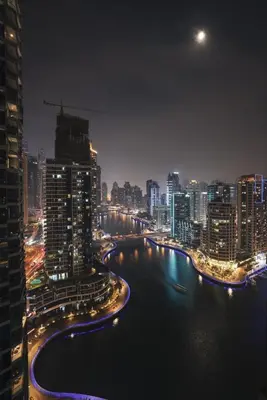 a city at night with a river and buildings at Bay Central Marina Suite with Exceptional Views in Dubai