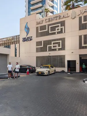two people standing in front of a bay central building at Bay Central Marina Suite with Exceptional Views in Dubai