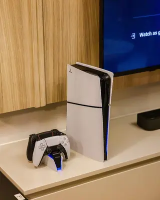 a video game controller sitting on a counter next to a tv at Bay Central Marina Suite with Exceptional Views in Dubai