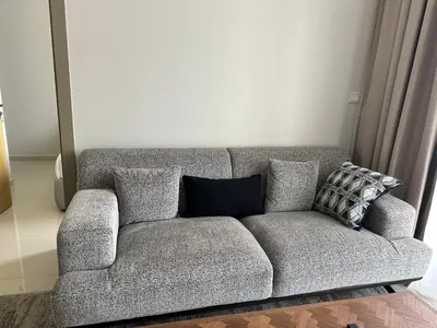 a gray couch with pillows in a living room at Skyline 2BR - AYKON CITY Tower C-Business Bay 5101 in Dubai