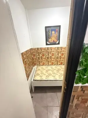 a walk in shower with a bench in a room at Cool valley homes in Dubai