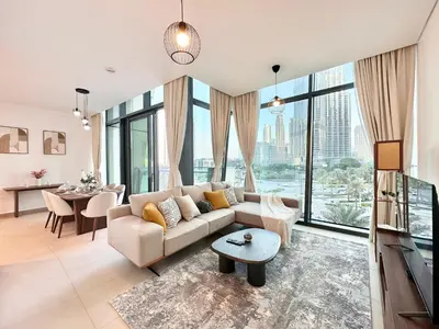 a living room with a couch and a table at Luxury 2BR with Full Burj Khalifa View in Dubai