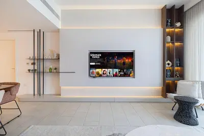 a living room with a tv on the wall at Luxurious 4BR La Vie JBR Private Beach Pool Panoramic Sea and Dubai Eye Views Drone Show Perfect for Family and Friends in Dubai