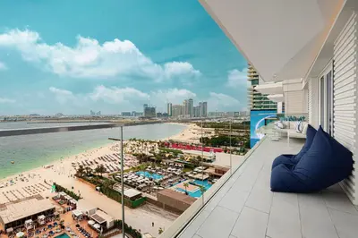 a view of the beach from the balcony of a resort at Luxurious 4BR La Vie JBR Private Beach Pool Panoramic Sea and Dubai Eye Views Drone Show Perfect for Family and Friends in Dubai