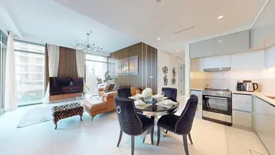 a kitchen and living room with a table and chairs at Vacationer l Classic 2 Bedroom l Marina Views l Private Beach in Dubai
