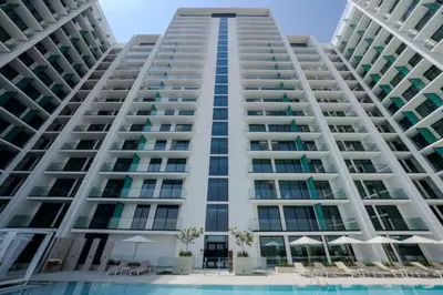 an image of a large apartment building with a swimming pool at Vacationer l Classy 2 Bedroom l Private Jacuzzi l near Circle Mall in Dubai