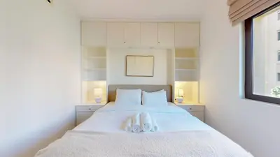 a bedroom with a bed with two towels on it at Vacationer l Upgraded Modern 2 Bed l Downtown l Near Dubai Mall in Dubai