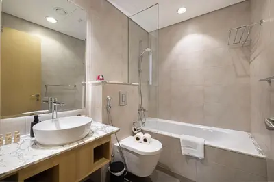 a bathroom with a sink and a toilet and a tub at Highest Infinity Pool - Paramount Midtown Hotel & Luxury Apartments Burj Khalifa view & Partial Fountain View in Dubai