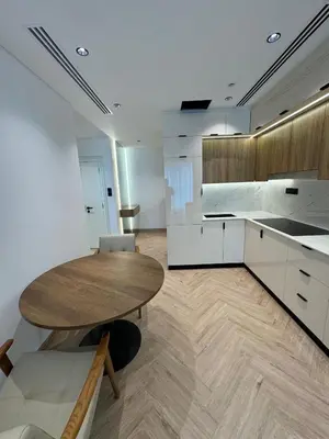 a kitchen with a wooden table in a room at Burj Khalifa & Canal View Apartment in Dubai