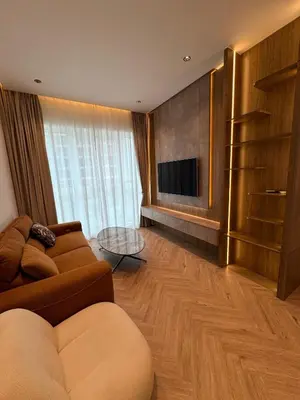 a living room with a couch and a flat screen tv at Burj Khalifa & Canal View Apartment in Dubai