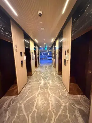a hallway in a building with a marble floor at Magra CHILL SPOT HOSTEL in Sabkhah