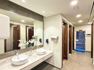 a bathroom with two sinks and a large mirror at Luxury 2BR Downtown Apartment - Canal & City Views in Dubai