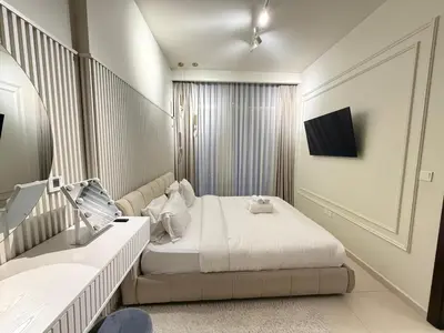 a bedroom with a bed and a television in it at Luxury 2BR Downtown Apartment - Canal & City Views in Dubai