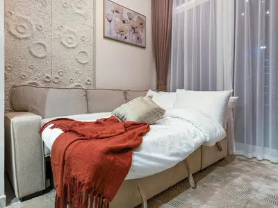 a bed with a red blanket on it in a room at Charming & Cozy 1BR Burj Khalifa Skyline View in Dubai