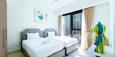 a hotel room with two beds and a window at Luxury in Dubai 2 bedroom apartment with balcony in Dubai
