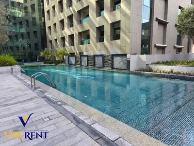 a swimming pool in front of a building at Business Bay Retreat,Views & Vibes,10 min to Burj in Dubai