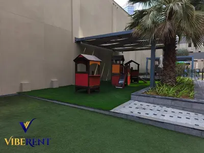 a playground in a building with green grass at Business Bay Retreat,Views & Vibes,10 min to Burj in Dubai