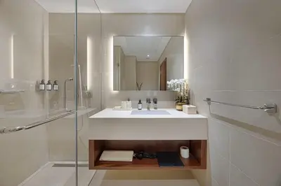 a bathroom with a sink and a glass shower at Livin' Holidays - 1 BR - Paradise getaway Dubai Marina in Dubai