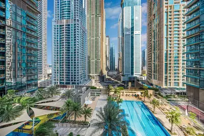 a pool in a city with tall buildings at Livin' Holidays - 1 BR - Paradise getaway Dubai Marina in Dubai