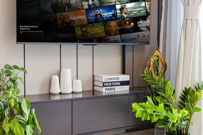 a shelf with a tv on a wall with books at Livin' Holidays - 1 BR - Paradise getaway Dubai Marina in Dubai